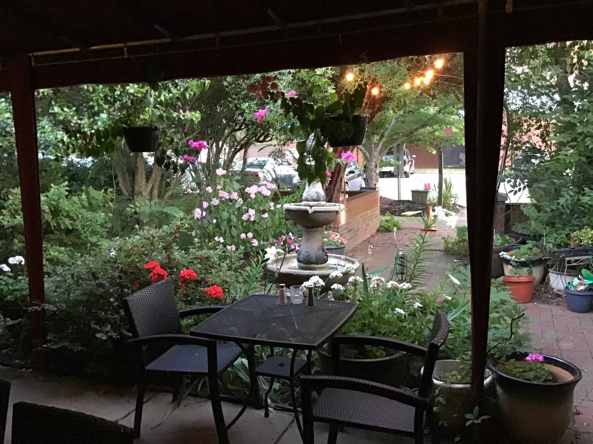 The garden patio with a fountain and string lights