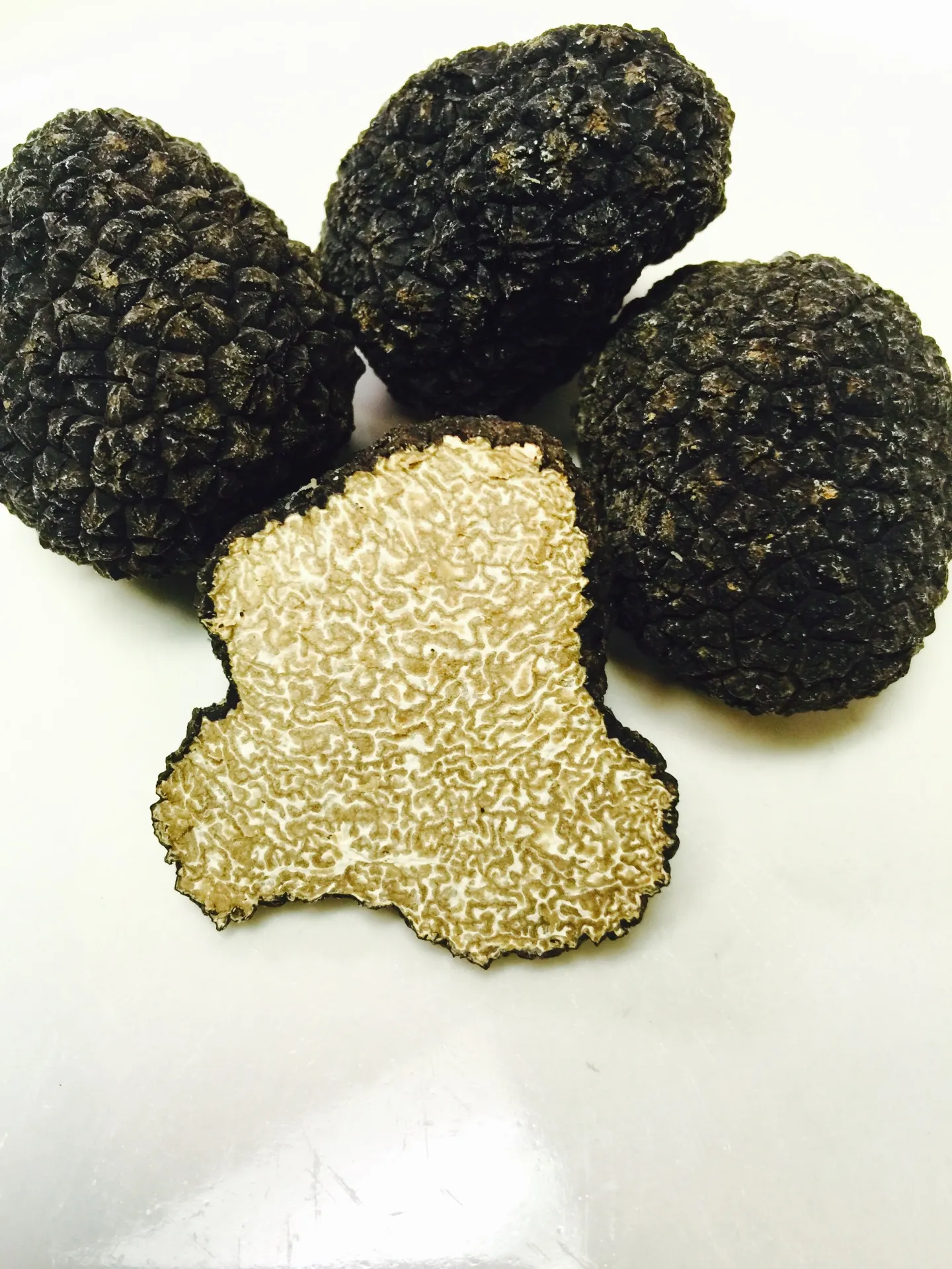 Black truffles, one sliced open